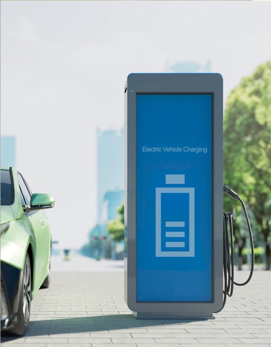 Electric vehicle charging point beside a parked car